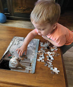 Child assembling the Barnyard Greetings holiday farm animal tray puzzle with colorful horse, sheep, dog, and cat pieces