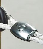 rope clamp crimped onto white electric polyrope at fence insulator