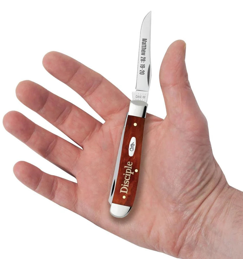 Case Disciple Chestnut Bone Mini Trapper pocket knife held in a hand with one blade open, showing its pocket size