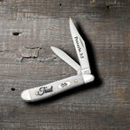 Case Religious Sayings Trust Peanut pocket knife with Clip and Pen blades open on a rustic wood surface, Proverbs 3:5 on the main blade and Trust script on the smooth natural bone handle