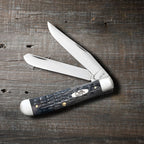 Case Pocket Worn Crandall Jig Gray Bone Trapper with both blades open on a wooden surface