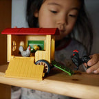 Child playing with Schleich Mobile Chicken Coop and chicken figures