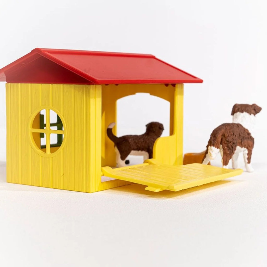 Rear view of Schleich Friendly Dog House with fold-down panel open, puppy inside and adult dog beside it.