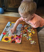 Child assembling the Sunshine Farm tray puzzle with large farm-themed pieces