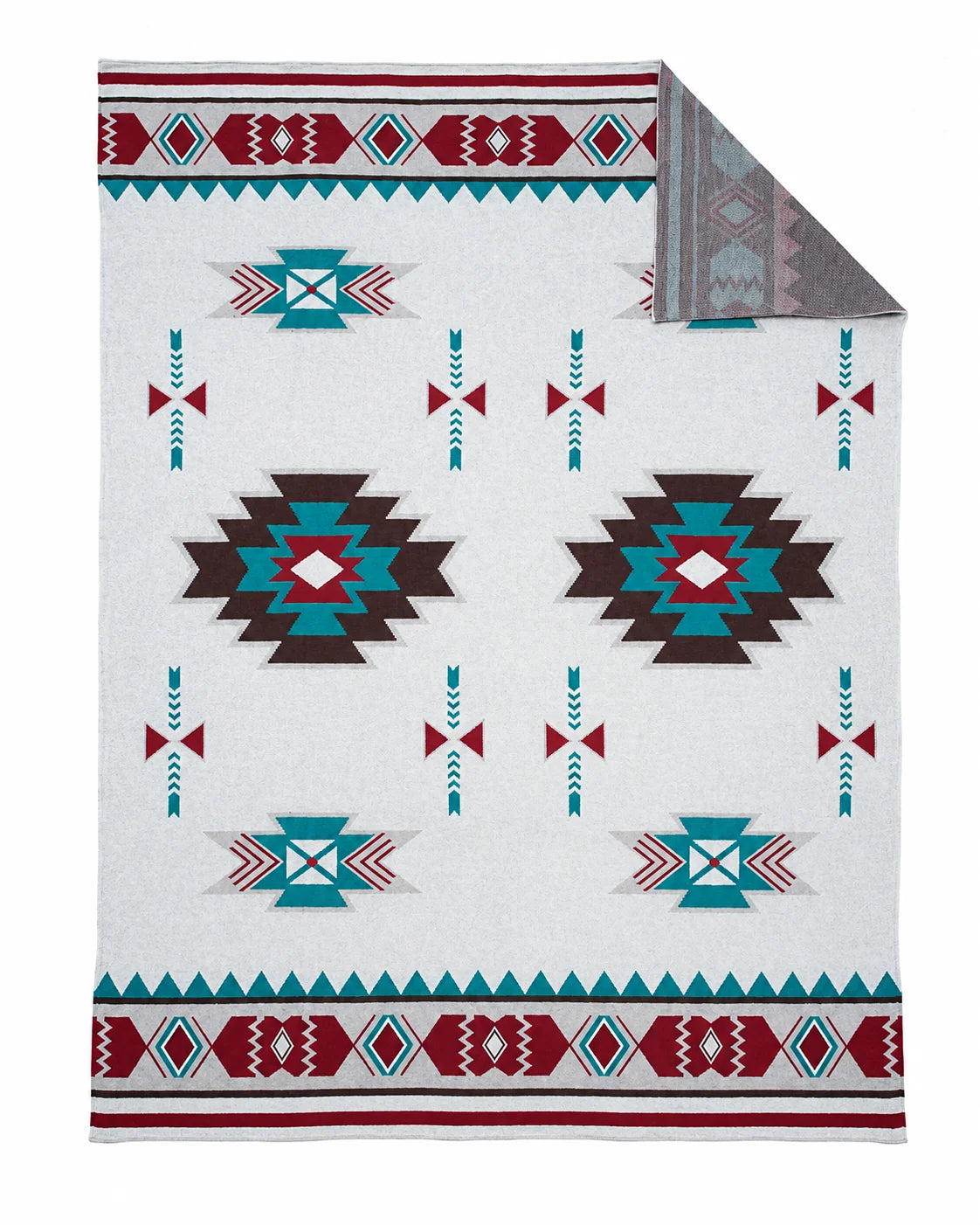 White throw blanket with turquoise, burgundy, and brown geometric motifs and patterned borders.