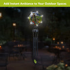 Country Birds wind chime hanging outdoors at night, with LED lights illuminating the round bird artwork above black chimes.