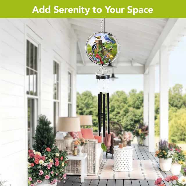 Country Birds wind chime hanging on a bright covered porch with colorful bird artwork, black chimes, and a green leaf wind catcher.
