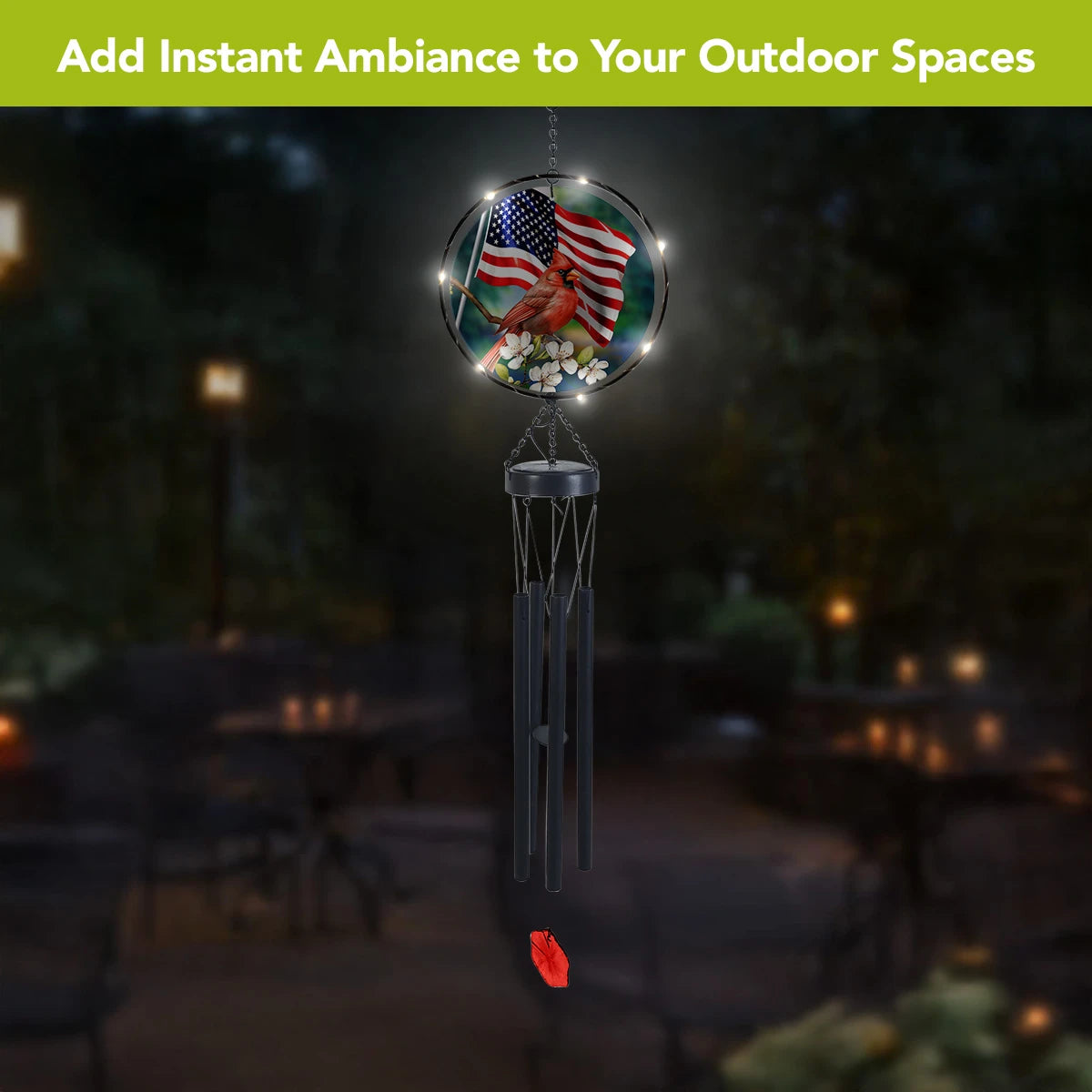 American Cardinal wind chime glowing with solar LED lights in an outdoor setting at night.