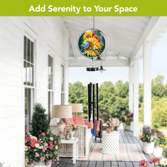 Birds in the Garden wind chime with colorful bird and sunflower artwork hanging on a furnished white porch.