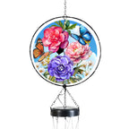 Close-up of the glass light catcher with blue and orange butterflies, pink and purple peonies, and a black circular frame.