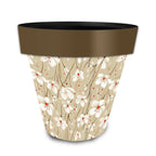 Medium Briarwood Lane planter with white flowers, red accents, a tan background, and a brown rim.