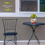 Stars and Stripes Truck planter filled with flowers on a black patio table beside a matching chair.