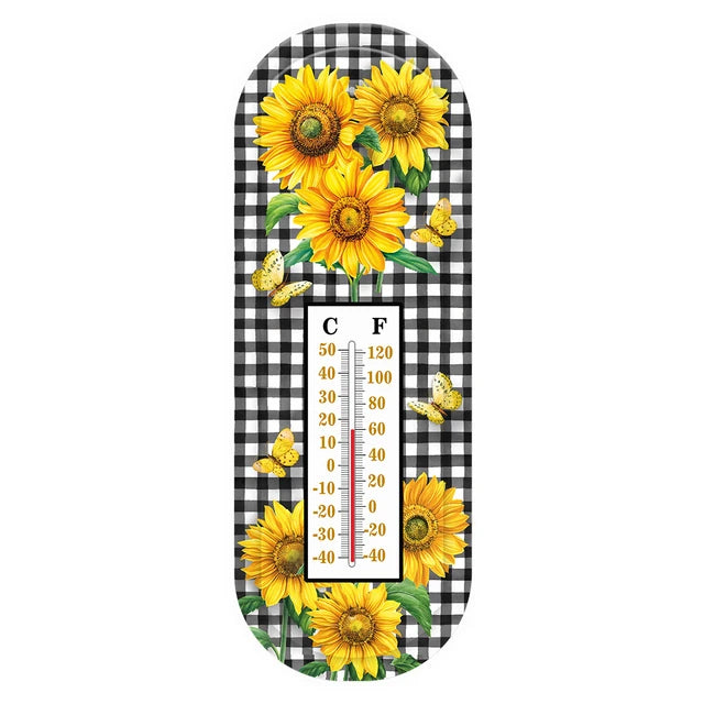 Metal thermometer with yellow sunflowers, butterflies, a black-and-white checkered background, and Celsius and Fahrenheit scales.