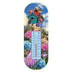 Metal thermometer with colorful birdhouses, perched birds, pink and blue flowers, and Celsius and Fahrenheit scales.