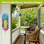 Hummingbird and floral metal thermometer mounted on a white screened porch wall beside wicker chairs.