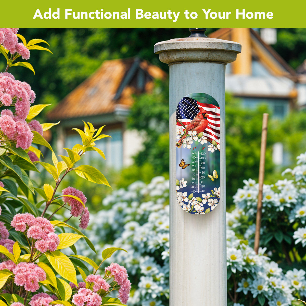 American Cardinal metal thermometer mounted on a white garden post surrounded by pink and white flowers