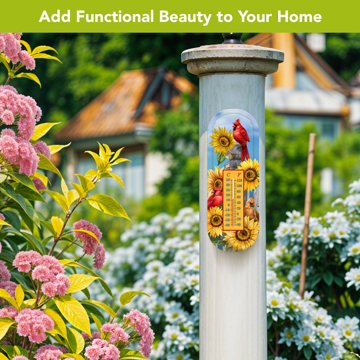 Cardinals and sunflowers metal thermometer mounted on a white garden post surrounded by pink and white flowers