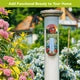 “American Barn thermometer mounted on a white garden post among colorful flowers.”