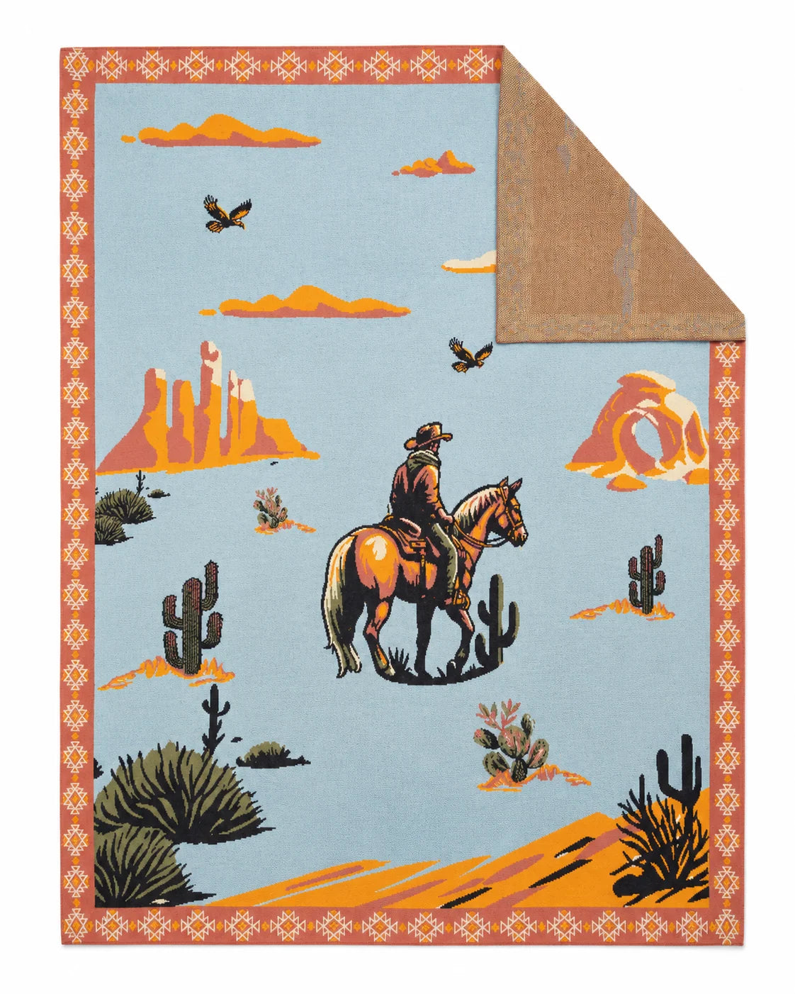 Throw blanket with a cowboy on horseback, desert scenery, and cactus on a pale blue background.