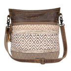 Front view of Myra Blending Taste Aztec Shoulder Bag with brown leather trim and neutral woven Aztec pattern