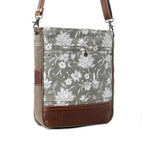 Angled view of Myra Blossom Print Shoulder Bag with floral print canvas, brown leather accents and shoulder strap