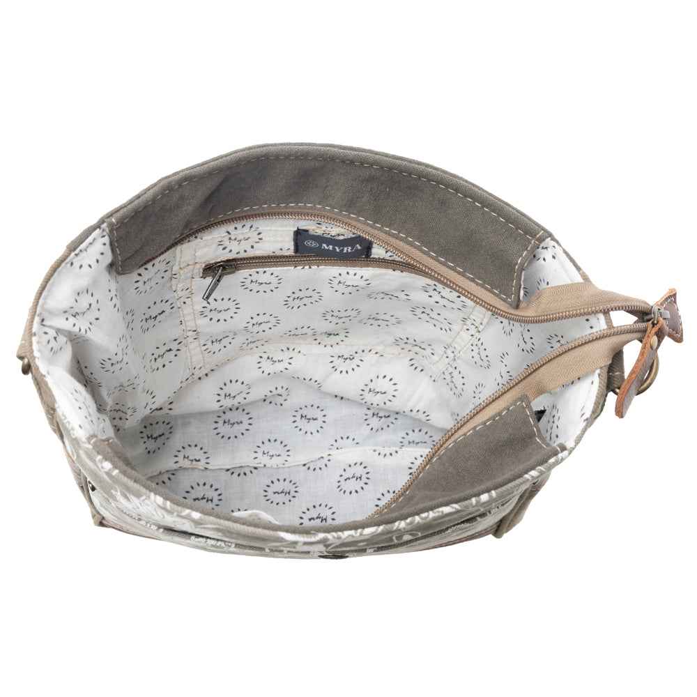 Interior view of Myra Blossom Print Shoulder Bag with patterned cotton lining and interior zipper pocket
