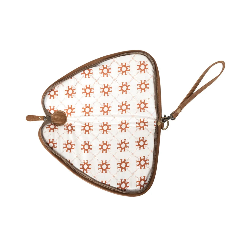 1. nterior view of the Myra Bronzefall Handtooled Leather Gun Case in Saddle Tan showing patterned lining, zipper closure, and wristlet strap.