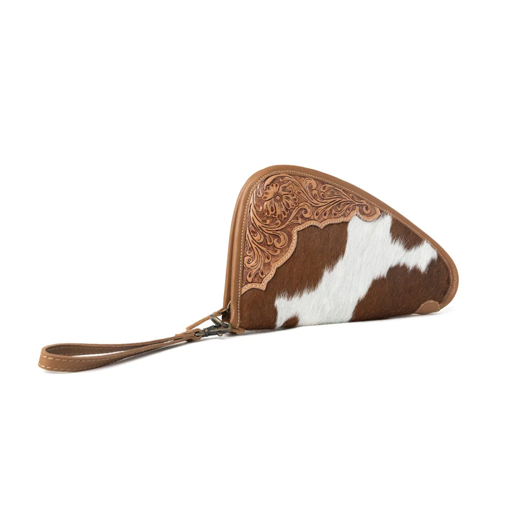 Angled view of Myra Cinder Oak hairon leather gun case in Sunlit Sand with tooled Western floral detailing