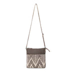 Full view of Myra Coffee Canvas Crossbody Bag with neutral geometric rug design and adjustable leather shoulder strap