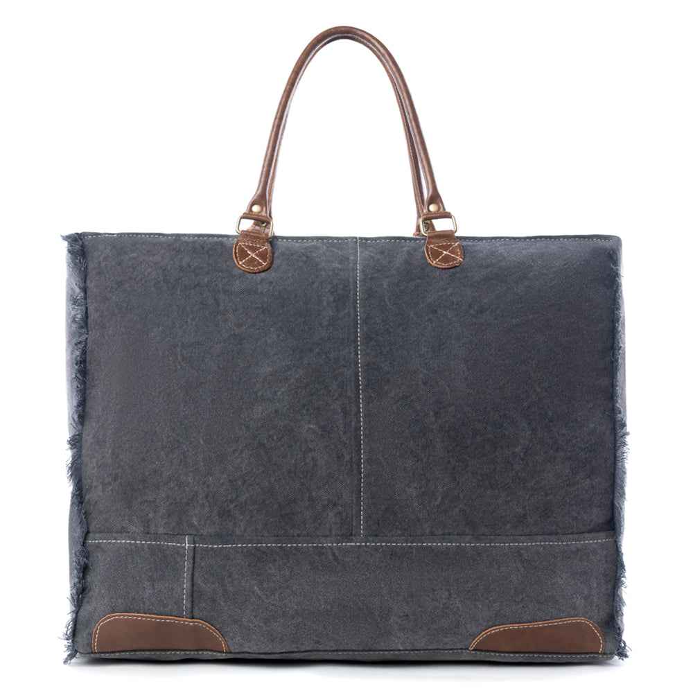 Back view of Myra Dakota Trail Weekender Bag with dark upcycled canvas, leather handles and leather corner accents