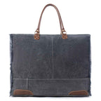 Back view of Myra Dakota Trail Weekender Bag with dark upcycled canvas, leather handles and leather corner accents