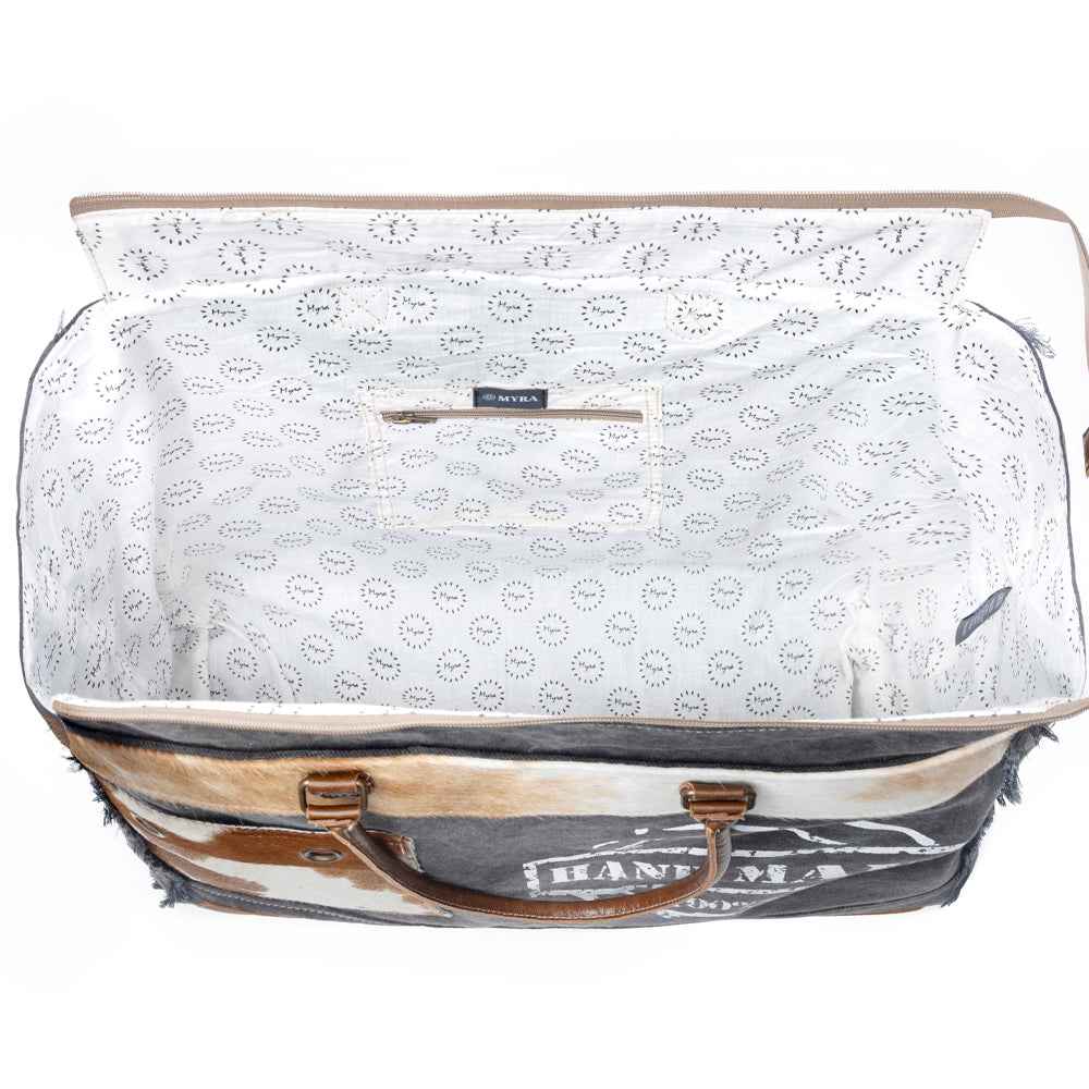 Interior view of Myra Dakota Trail Weekender Bag with patterned cotton lining and interior zipper pocket