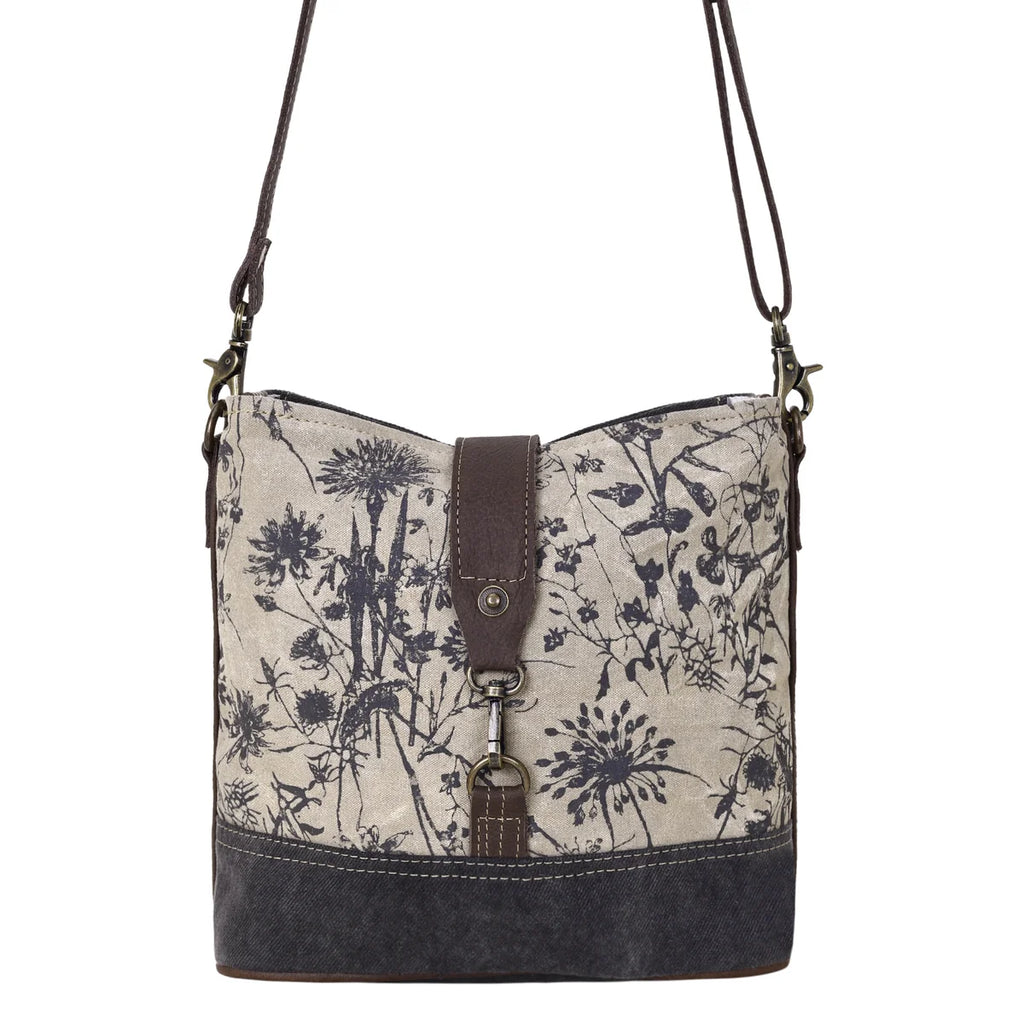 Front view of Myra Debonair Floral Shoulder Bag with botanical print canvas, dark canvas base and leather accents