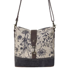 Front view of Myra Debonair Floral Shoulder Bag with botanical print canvas, dark canvas base and leather accents