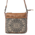 Front view of Myra Dizzy Circle Floral Shoulder Bag with sunburst floral print and brown genuine leather accents