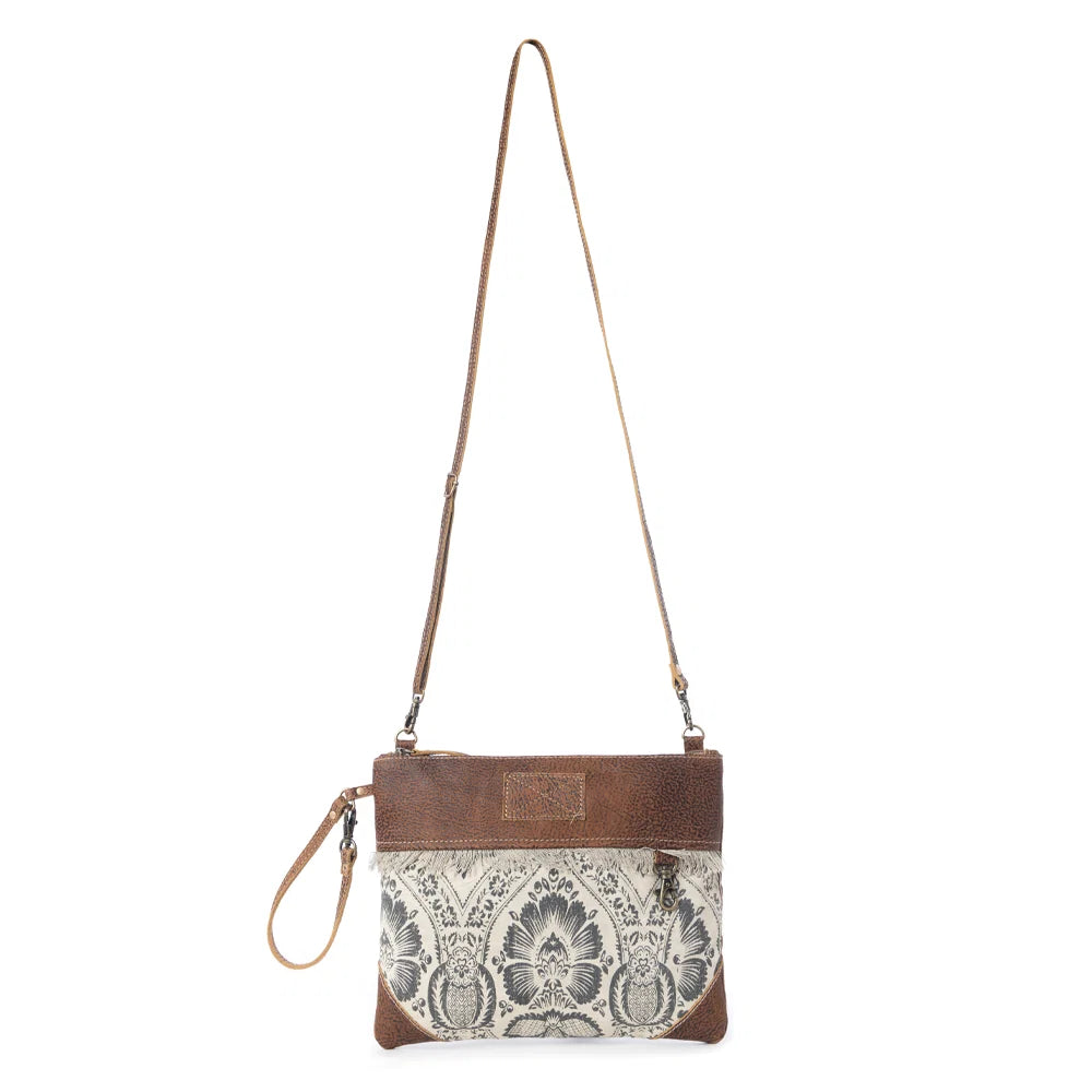 Full view of Myra Floral Flow Crossbody Bag with adjustable leather crossbody strap and wrist strap