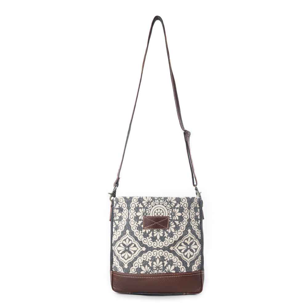 Full view of Myra Freaky Leather Shoulder Bag with floral rug pattern, brown leather trim and adjustable shoulder strap