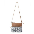 Full view of Myra Itsy Bitsy Crossbody Bag with floral rug design, brown leather and adjustable shoulder strap