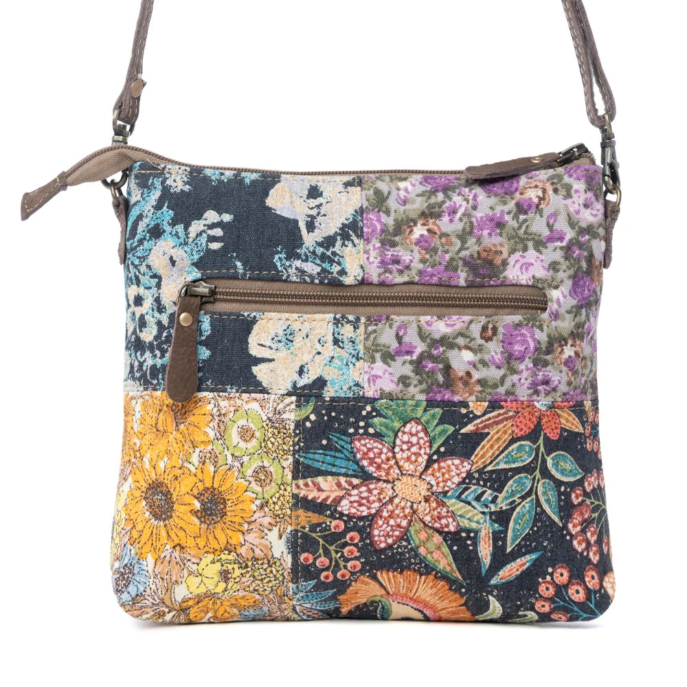 Back view of Myra La Fleur Patchwork Crossbody Bag with colorful floral canvas panels and exterior zipper pocket