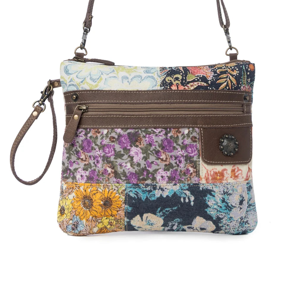 Front view of Myra Le Piccolo Crossbody Bag with floral patchwork, brown leather trim and exterior zipper pocket