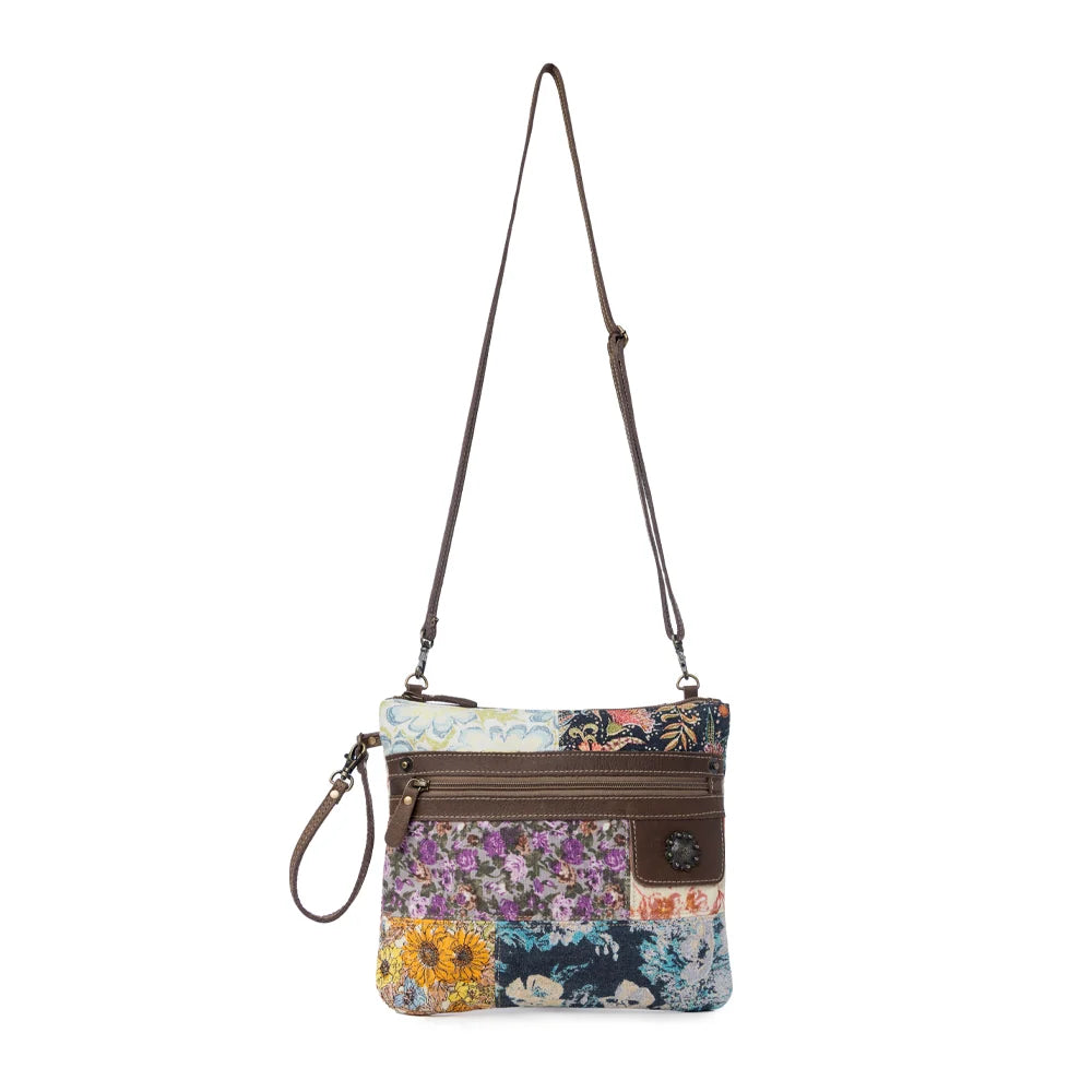 Full view of Myra Le Piccolo Crossbody Bag with floral patchwork, adjustable leather crossbody strap and wrist strap