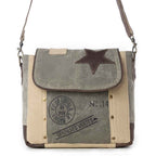 Front view of Myra Leather Star Shoulder Bag with green and beige canvas, brown leather star detail and printed accents