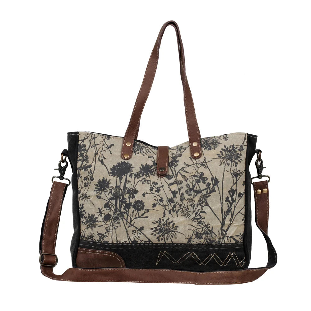 Myra Mystique floral canvas and leather messenger bag with shoulder handles and adjustable crossbody strap.