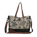 Myra Mystique floral canvas and leather messenger bag with shoulder handles and adjustable crossbody strap.