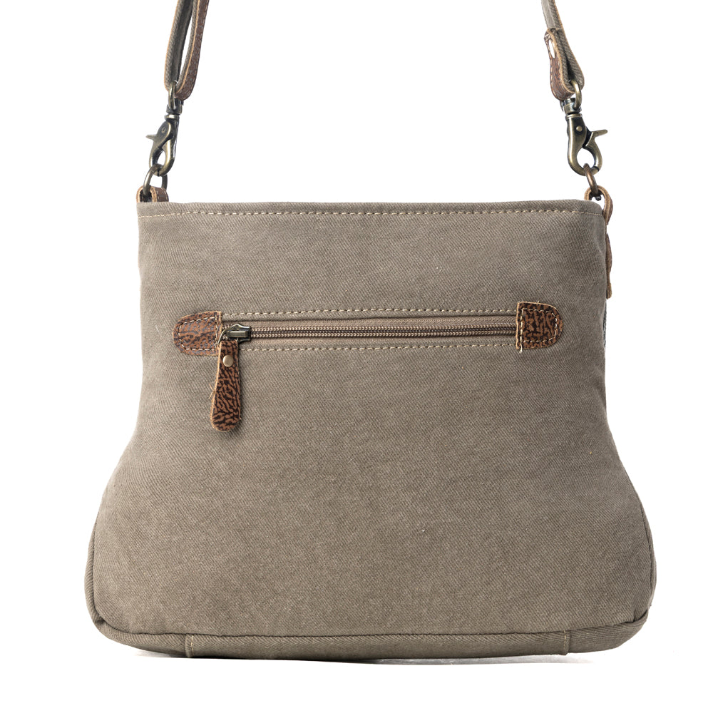 Back view of Myra Saplings Shoulder Bag with gray canvas and exterior zipper pocket with leather accents