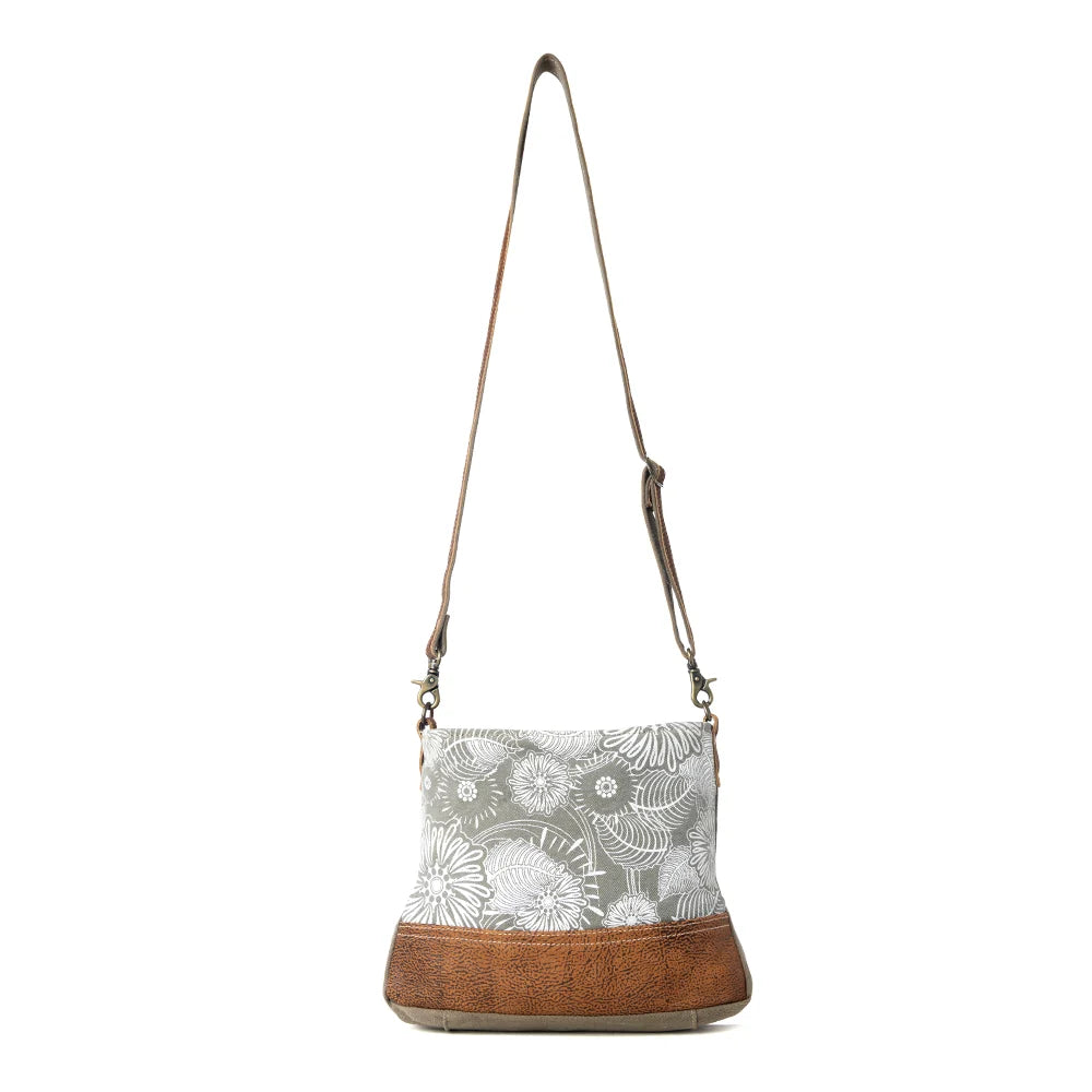 : Full view of Myra Saplings Shoulder Bag with floral canvas, brown genuine leather trim and adjustable shoulder strap