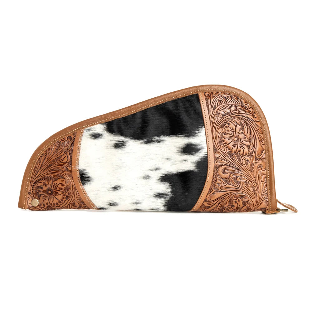 Front view of Myra Sonoran Range Western hairon gun case with black and white cowhide pattern and floral tooled leather