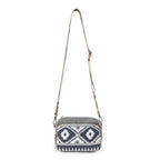 Full view of the Myra Temptation Tribal Crossbody Bag with black and white geometric pattern and adjustable leather shoulder strap.