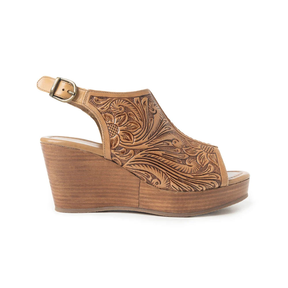 Side view of Myra tan leather wedge sandal with floral scrollwork and adjustable buckle slingback.