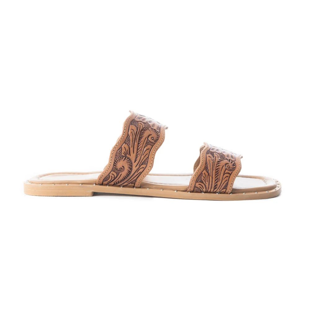 Side view of Myra Santa Fe Daisy leather sandal showing two tooled straps and a flat sole.